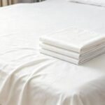 Finished disposable nonwoven bed sheet for hotel travel and medical use