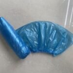 Finished blue disposable PE plastic shoe cover produced by automatic machine