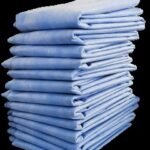 Neatly folded nonwoven fitted bed covers ready for packaging