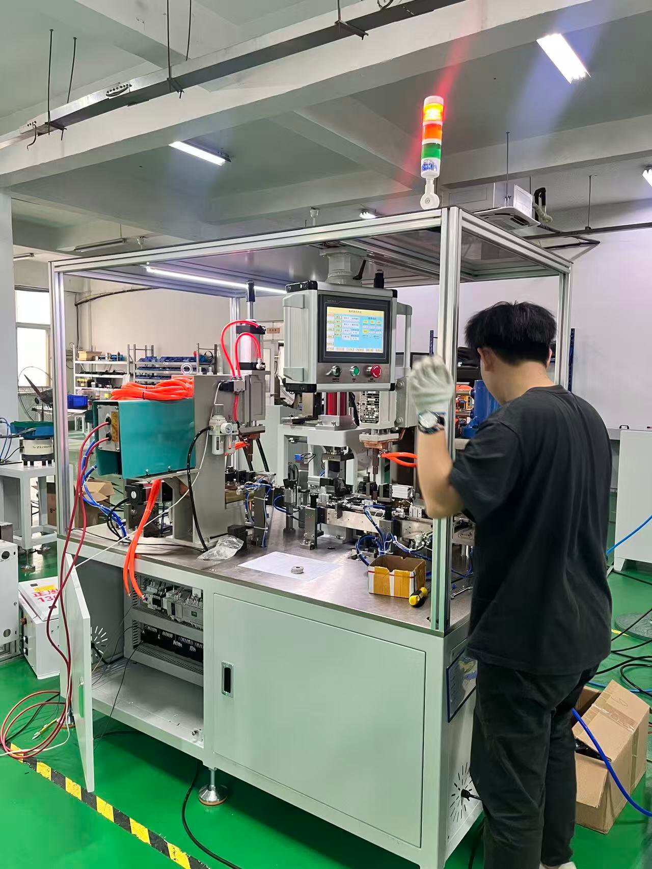 Factory worker operating an automated equipment assembly station at Sunlay Automation.