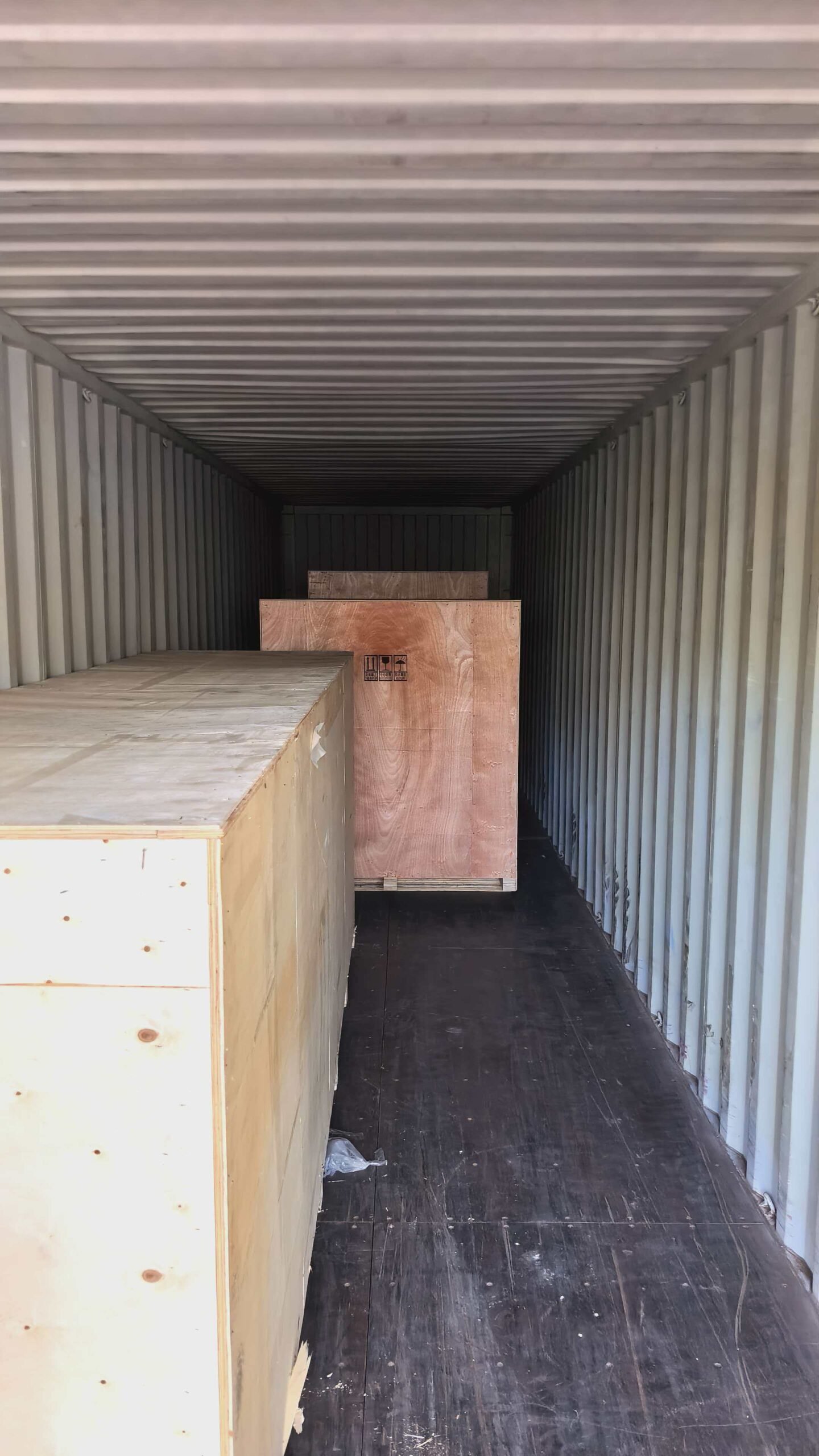 Export wooden crates positioned inside a shipping container.