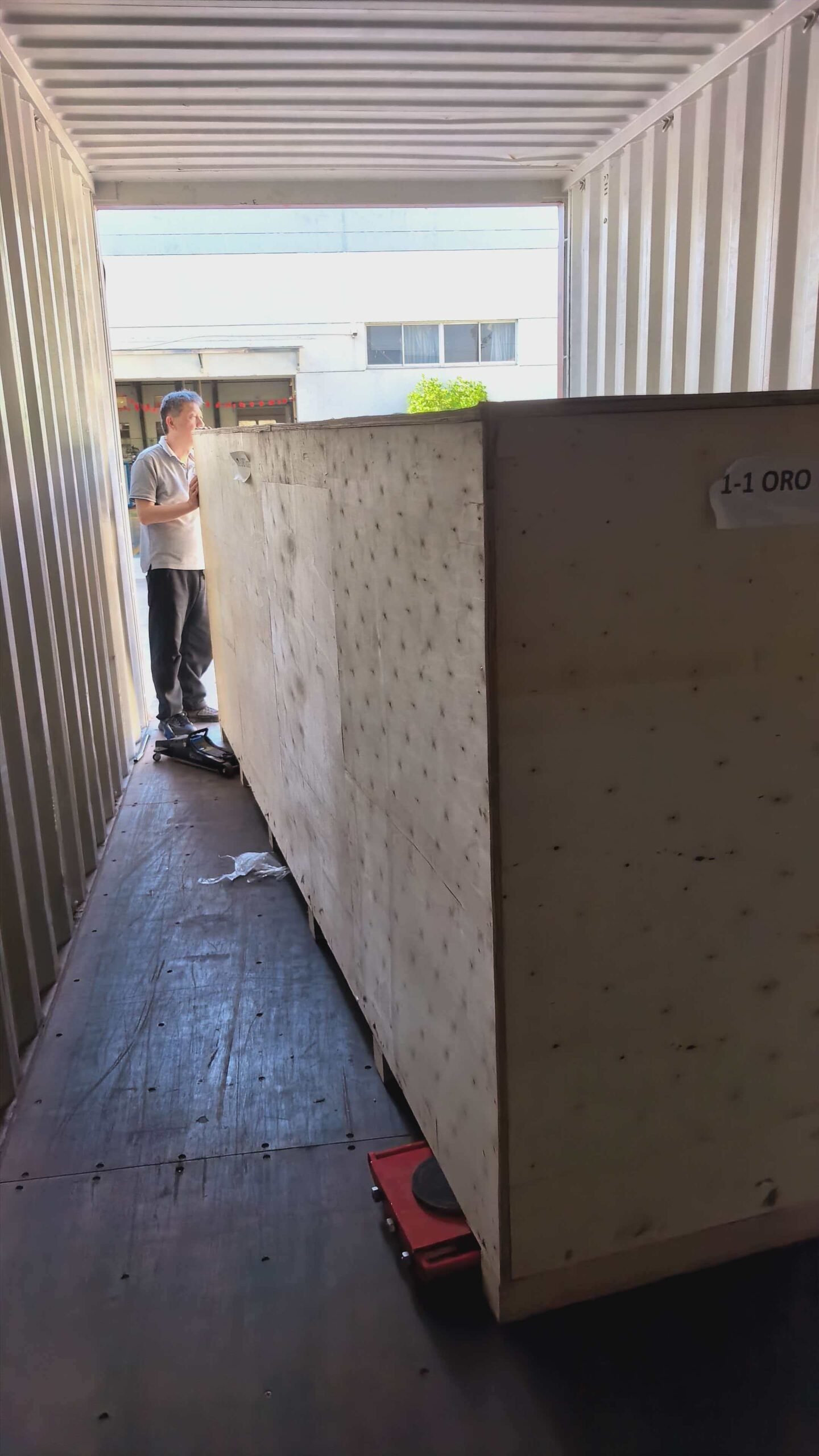 Industrial equipment crates loaded inside a shipping container.